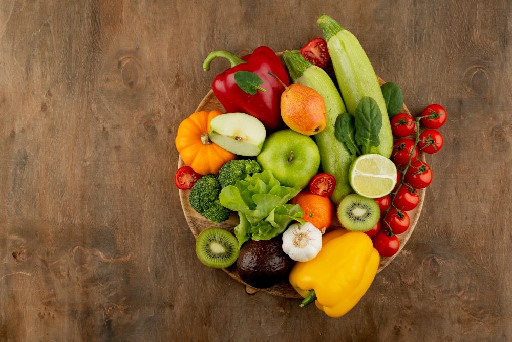 Colorful fruits and vegetables on a wooden surface.